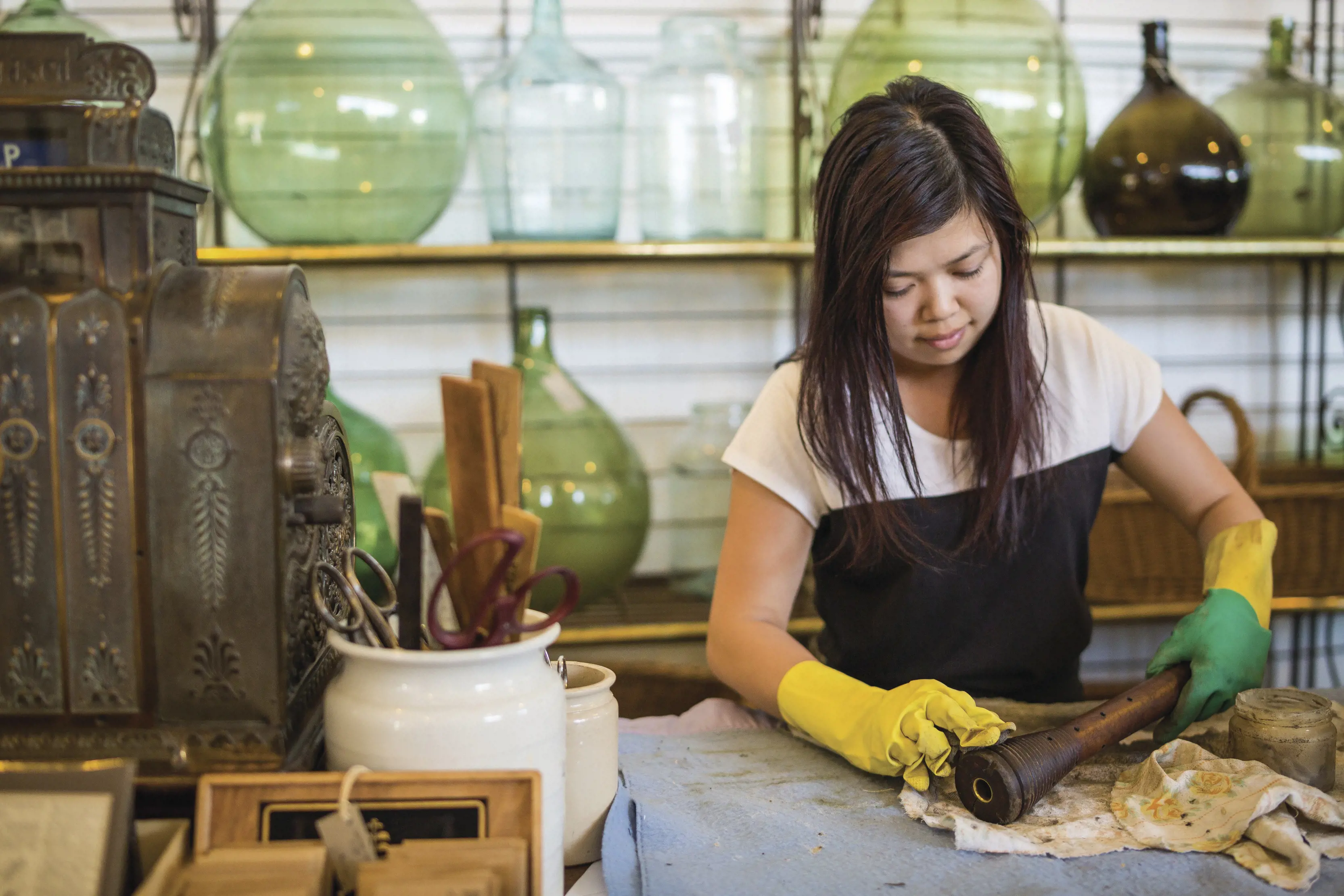 Staff wrap a customers purchase in paper at The Drill Hall Emporium antiques store