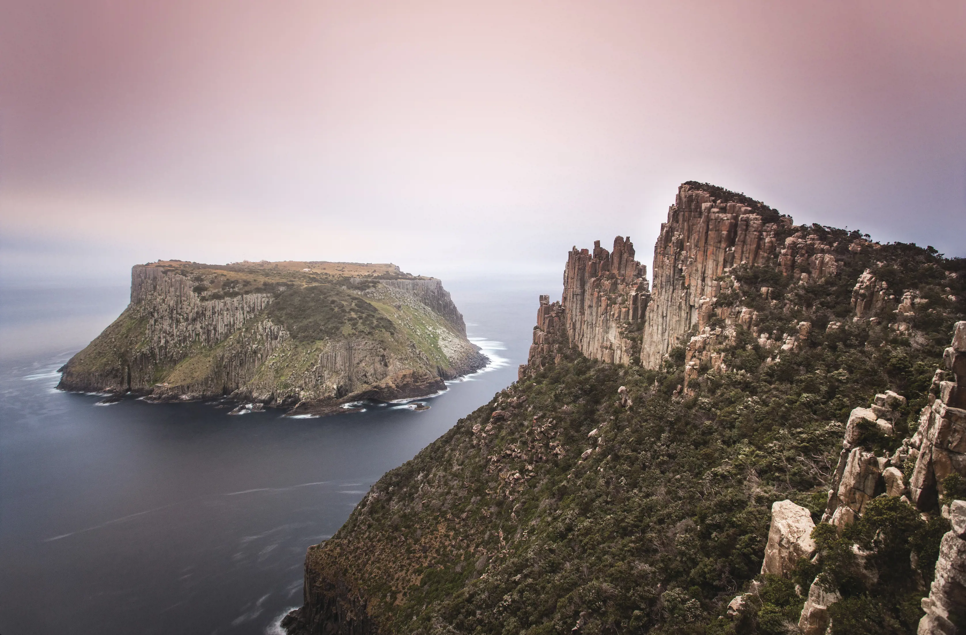 Aerial image with pink skies at Three Capes Track - Tasman Island