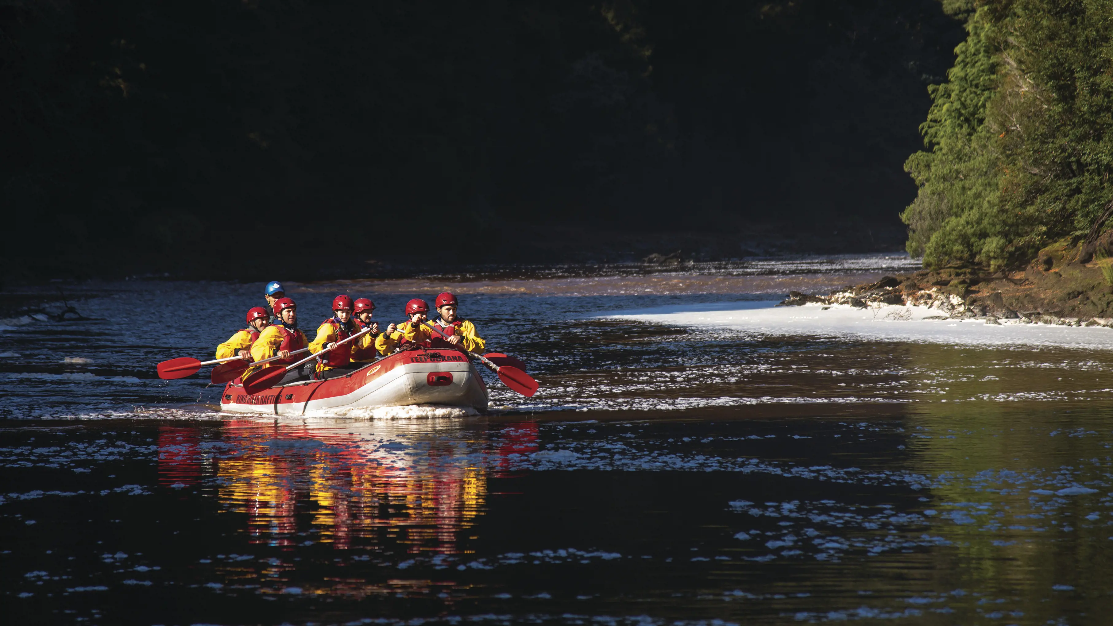 Tourists and tour guide river rafting with King River Steam River & Raft Experience - King River Rafting.