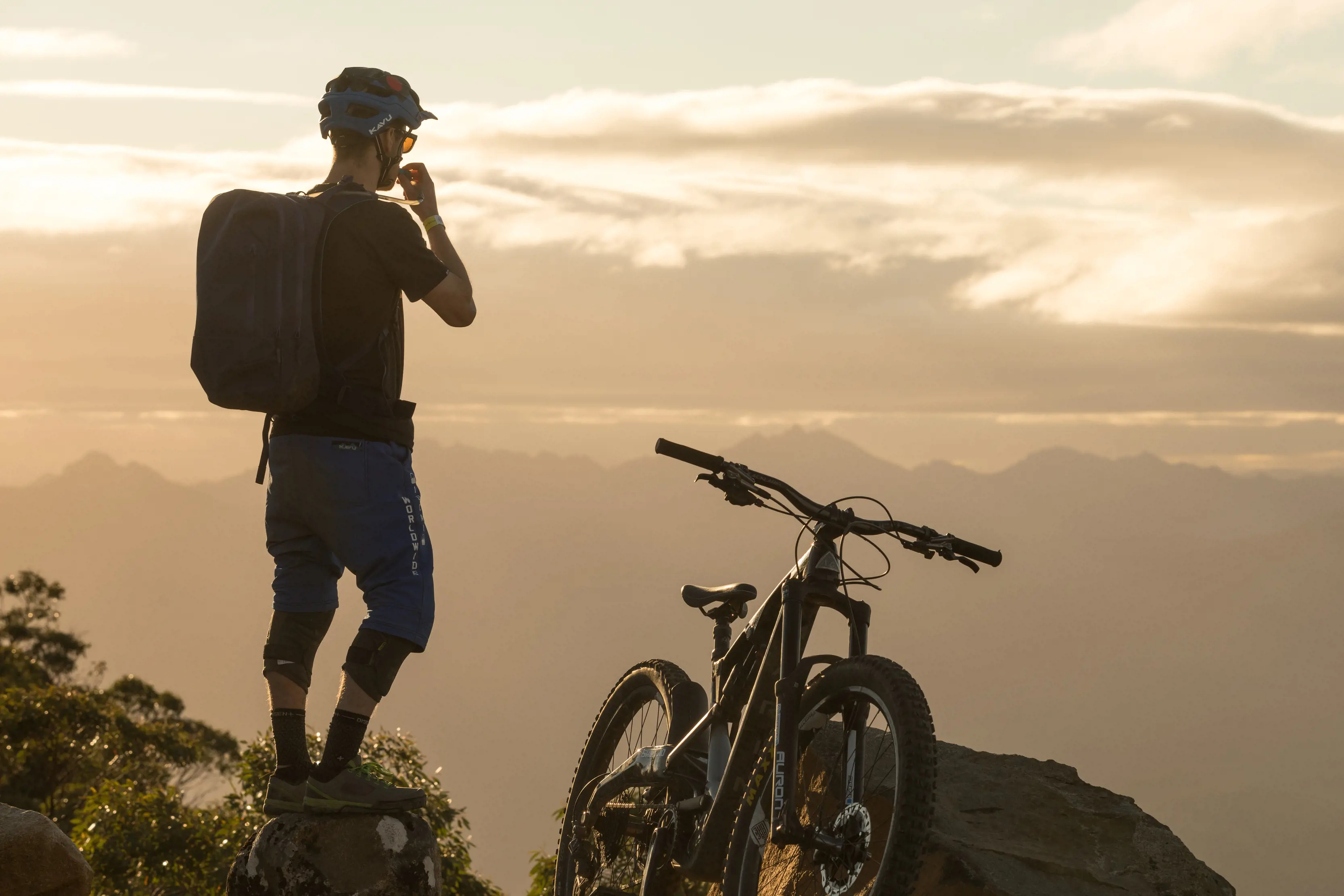 A cyclist steps off his bike to look at the views at Maydena Bike Park