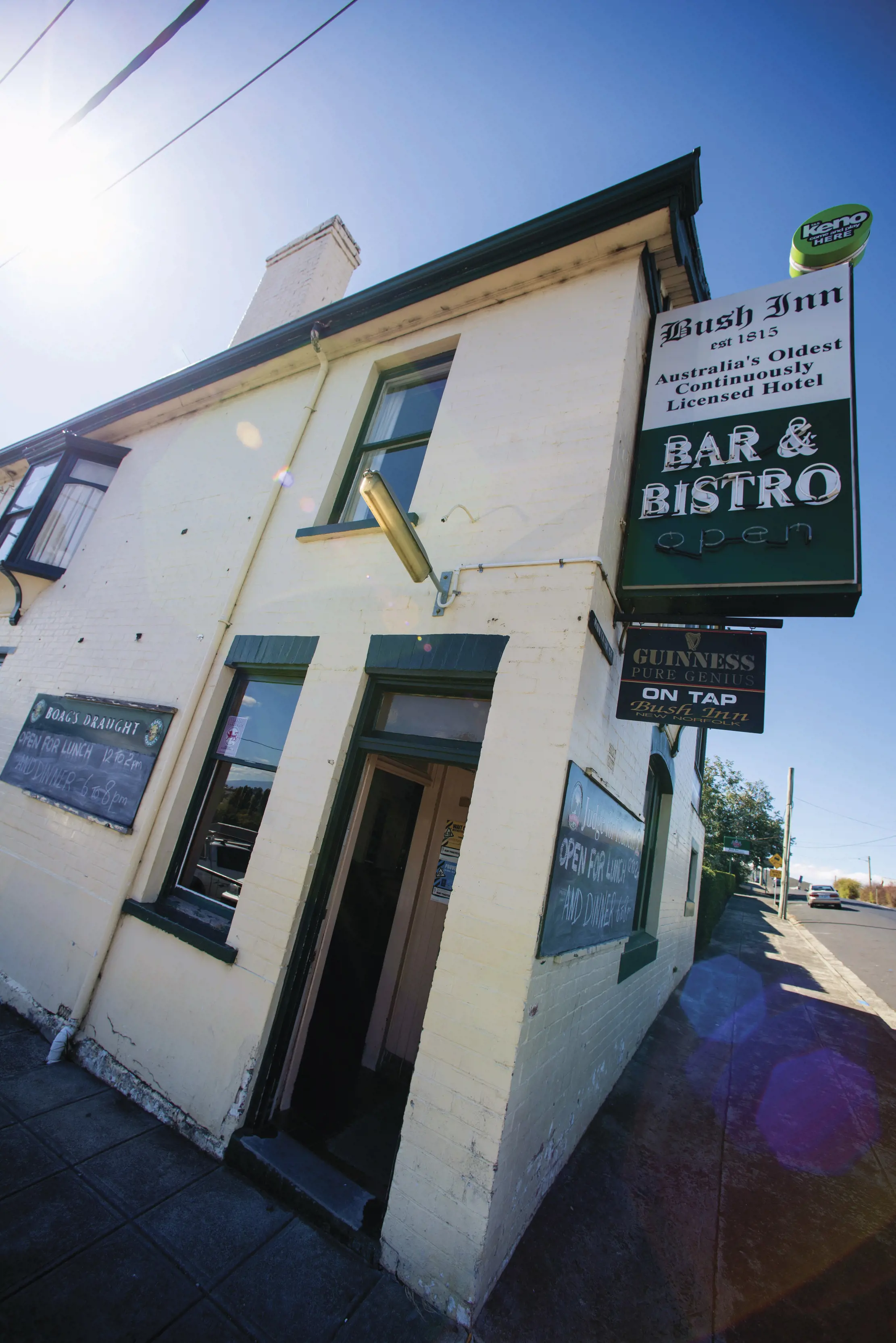 Exterior side angle of the Bush Inn Bar and Bistro with signage on the wall.