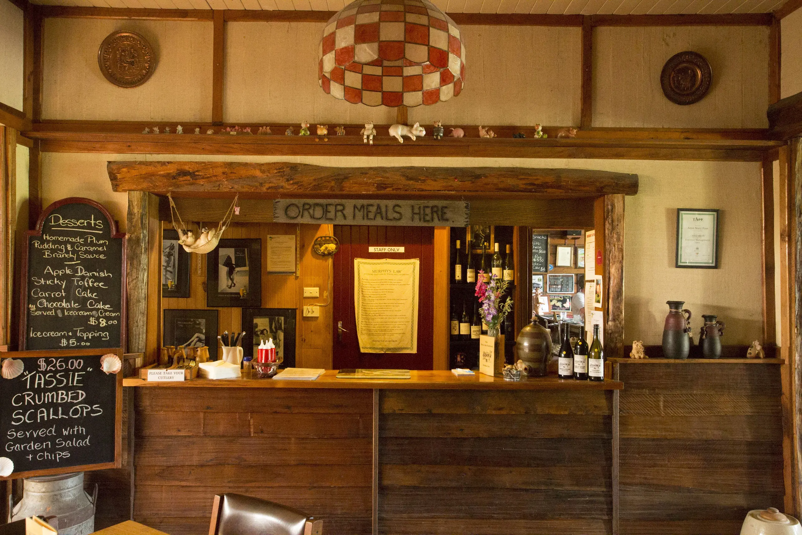 Interior of the bar at the Pub in the Paddock, the menu is written on chalk boards.