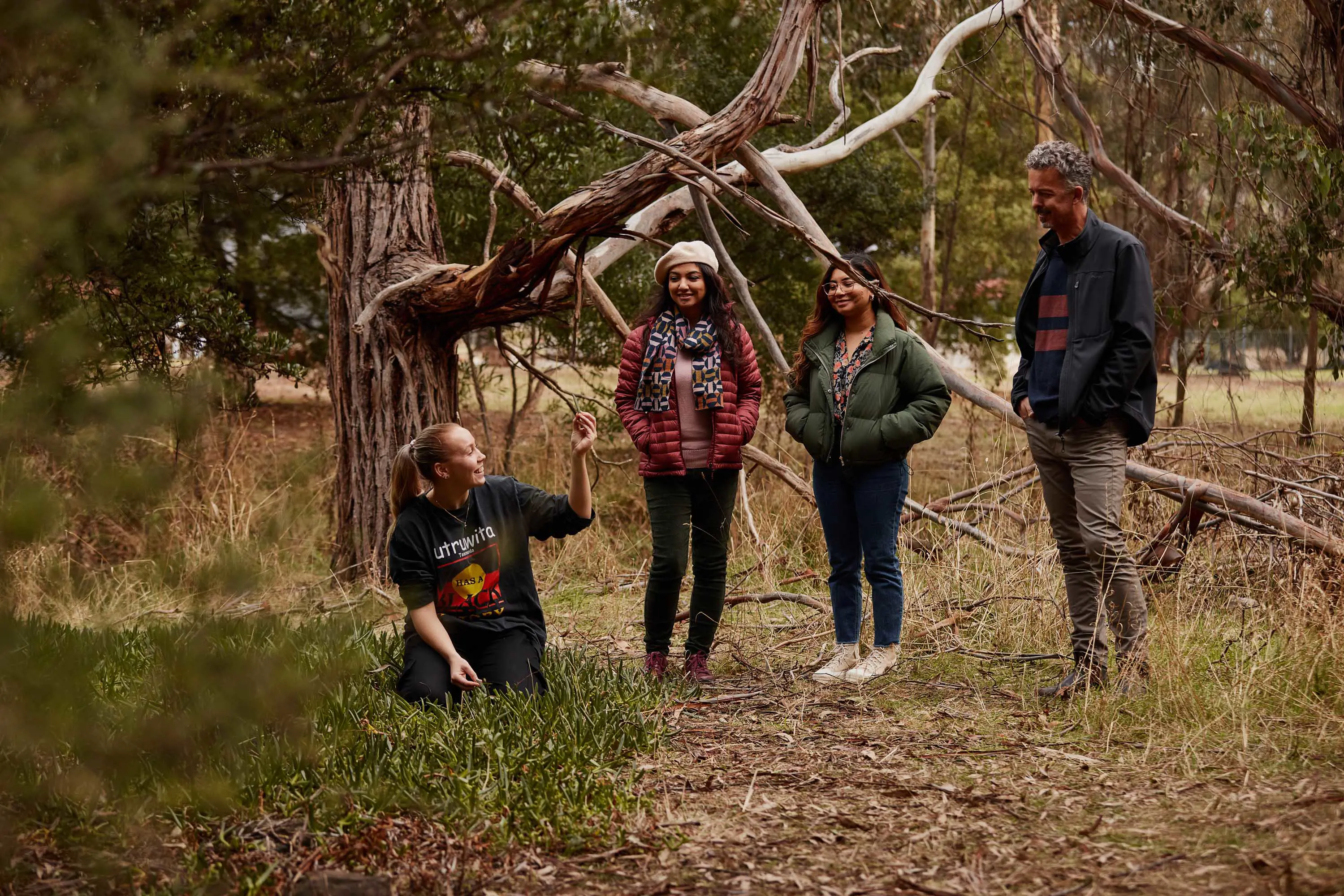 A small group of guests stand with the guide on an outdoor tour.