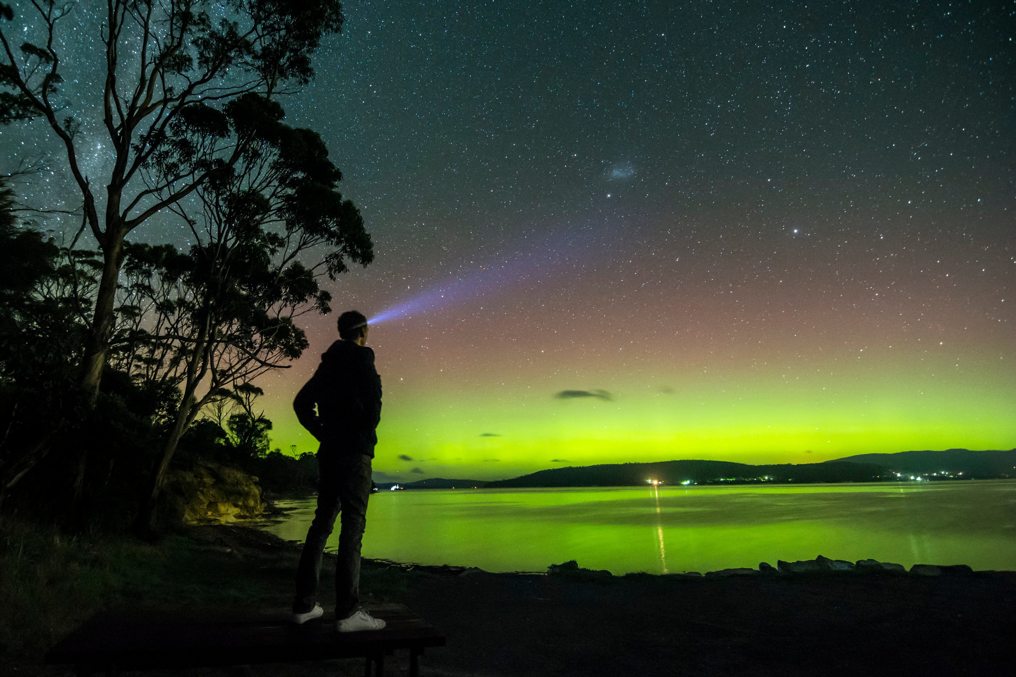 A man at night time looking at the Aurora Australis, Howden