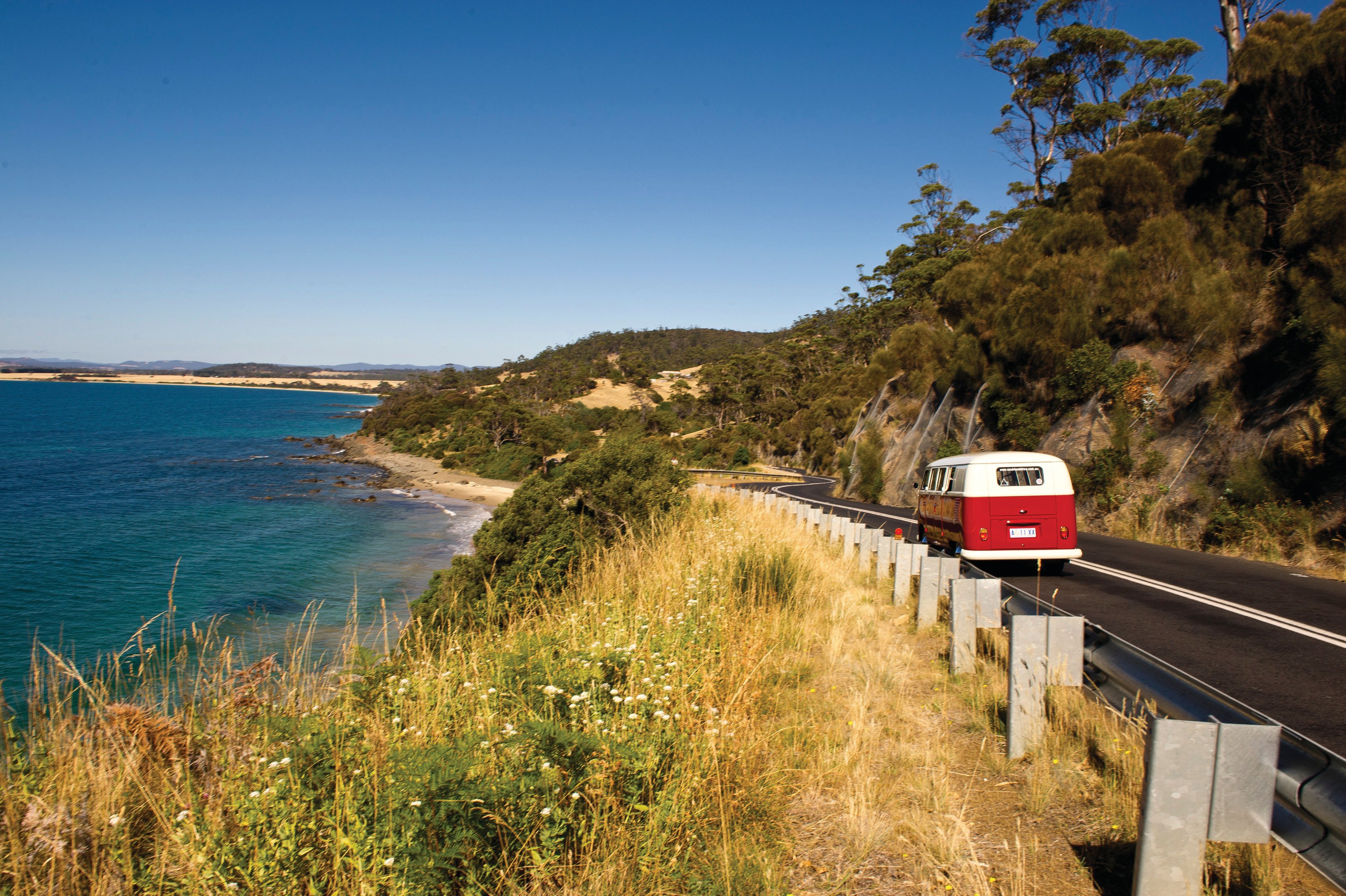 A campervan touring past Swansea Coastline, on Tasman Highway.