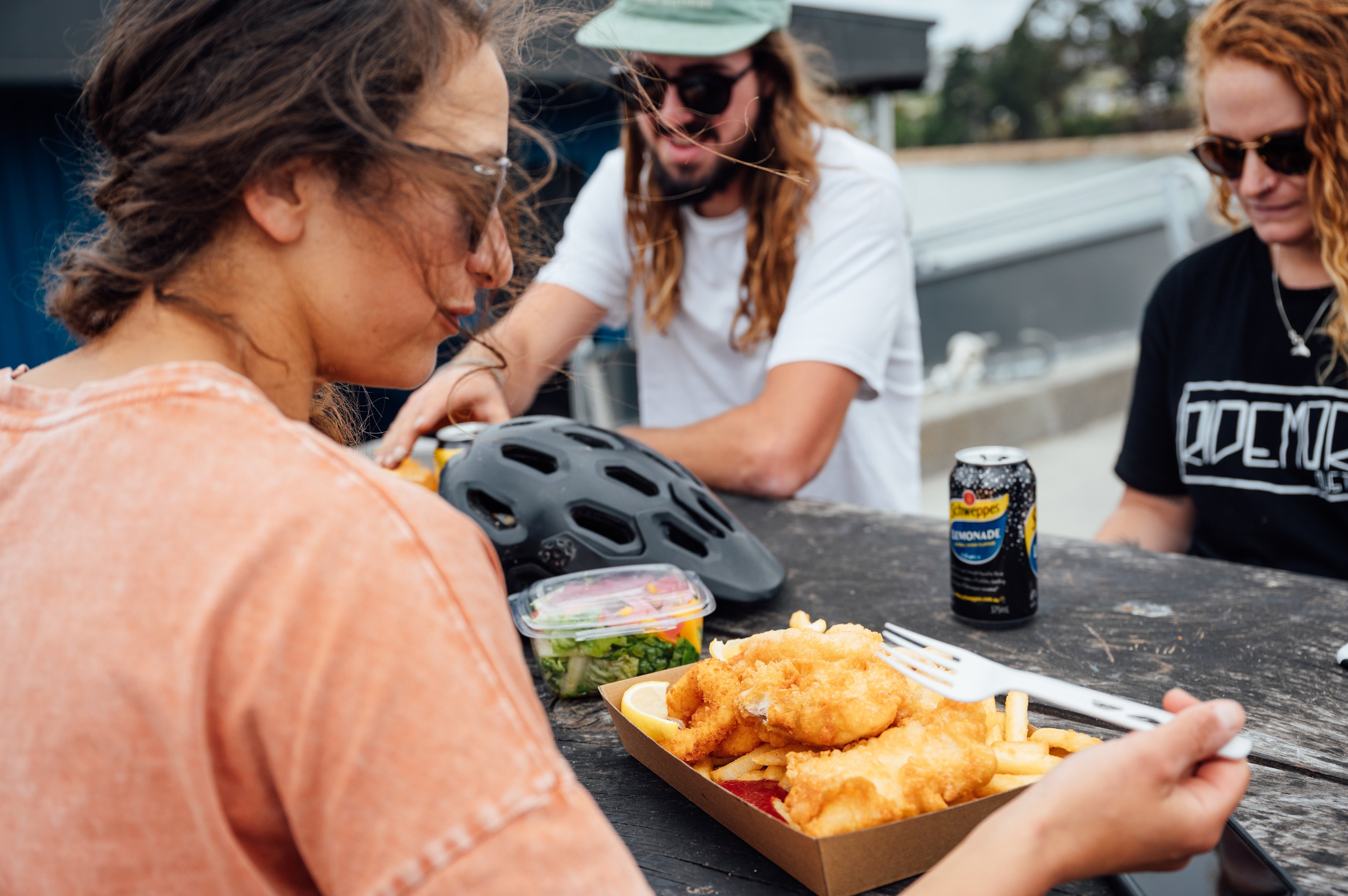 Group of three eating fish and chips at Skippers Fish Shop.