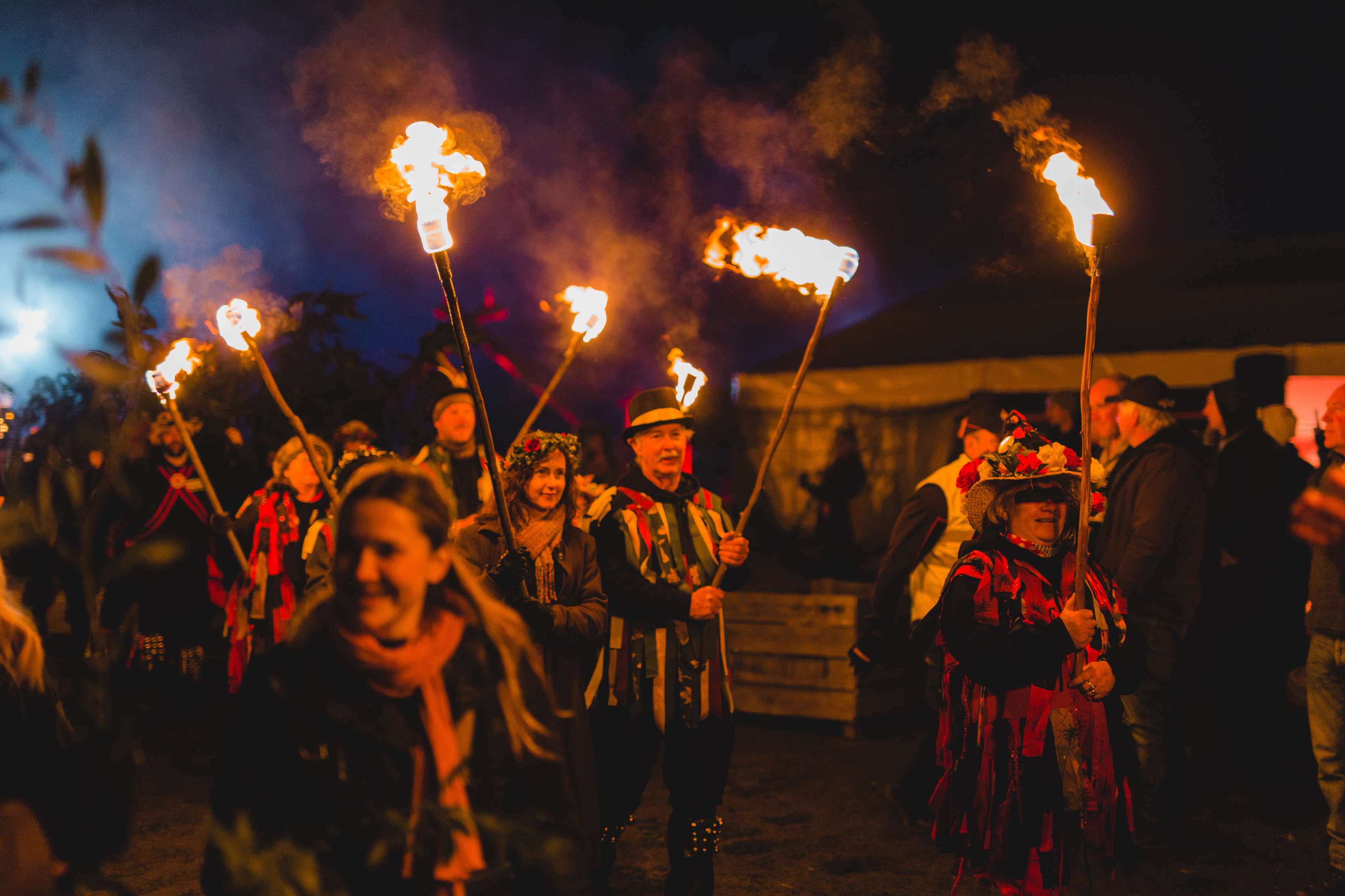 Crowd walking through, waving fire torches through the crowd at the Huon Valley Mid-Winter Fest.