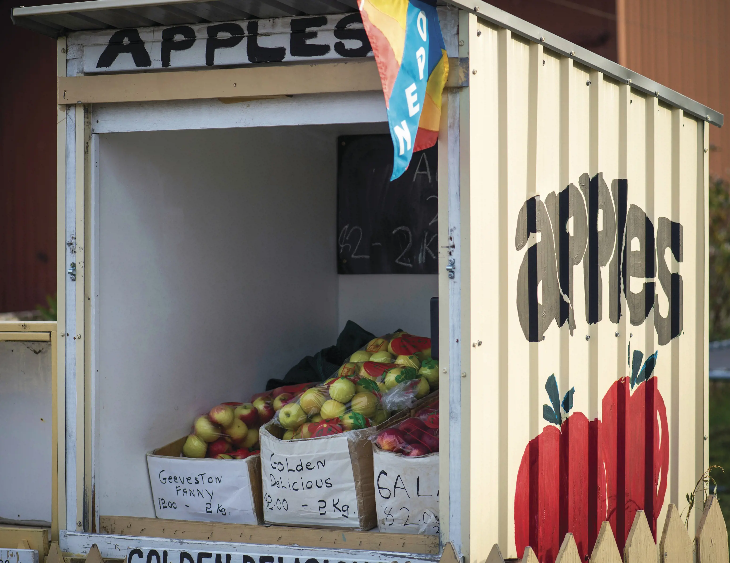 A roadside apple stall, filled with boxes of different types of apples, in Huonville.