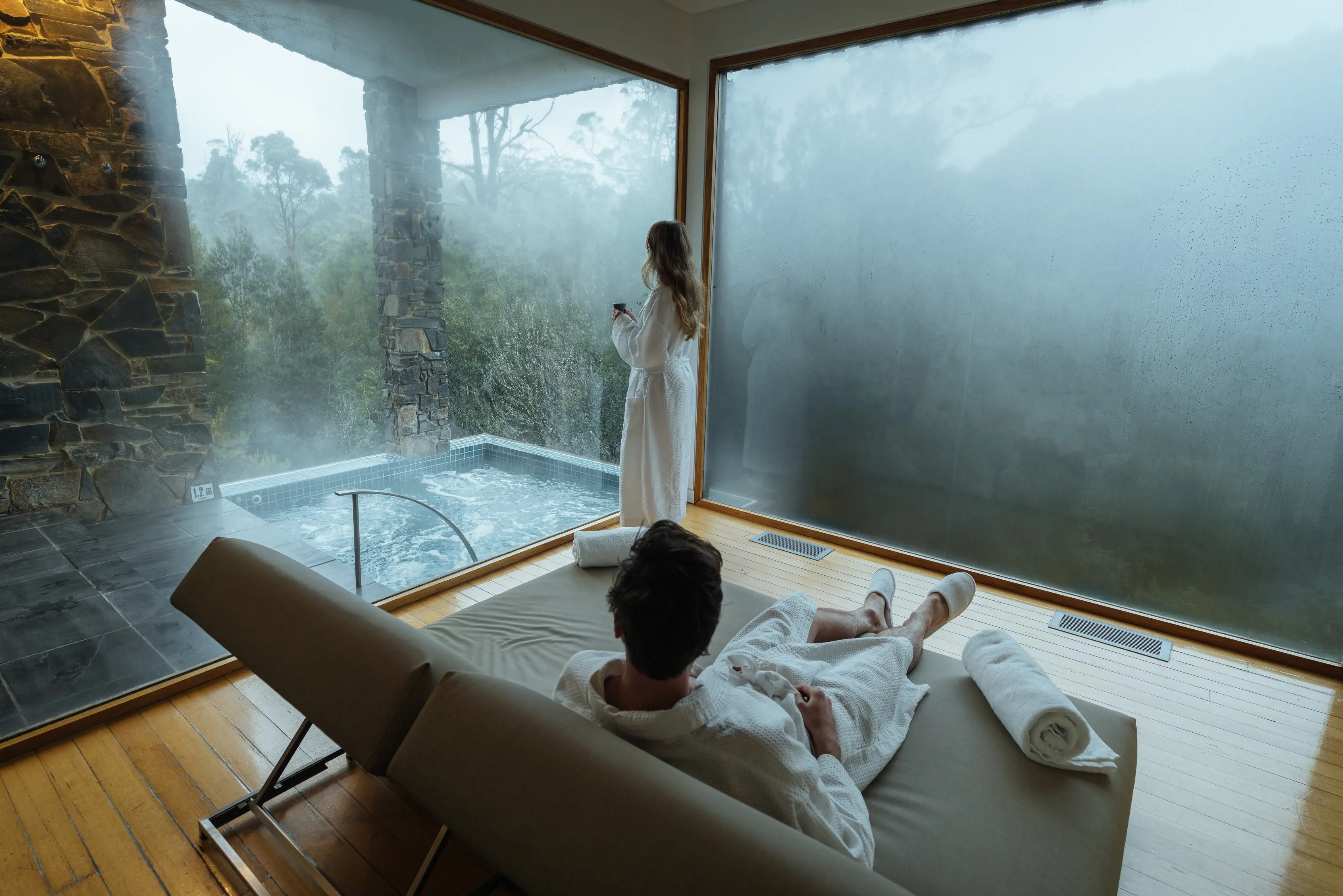 Couple relaxing at the Waldheim Alpine Spa at Peppers Cradle Mountain Lodge.