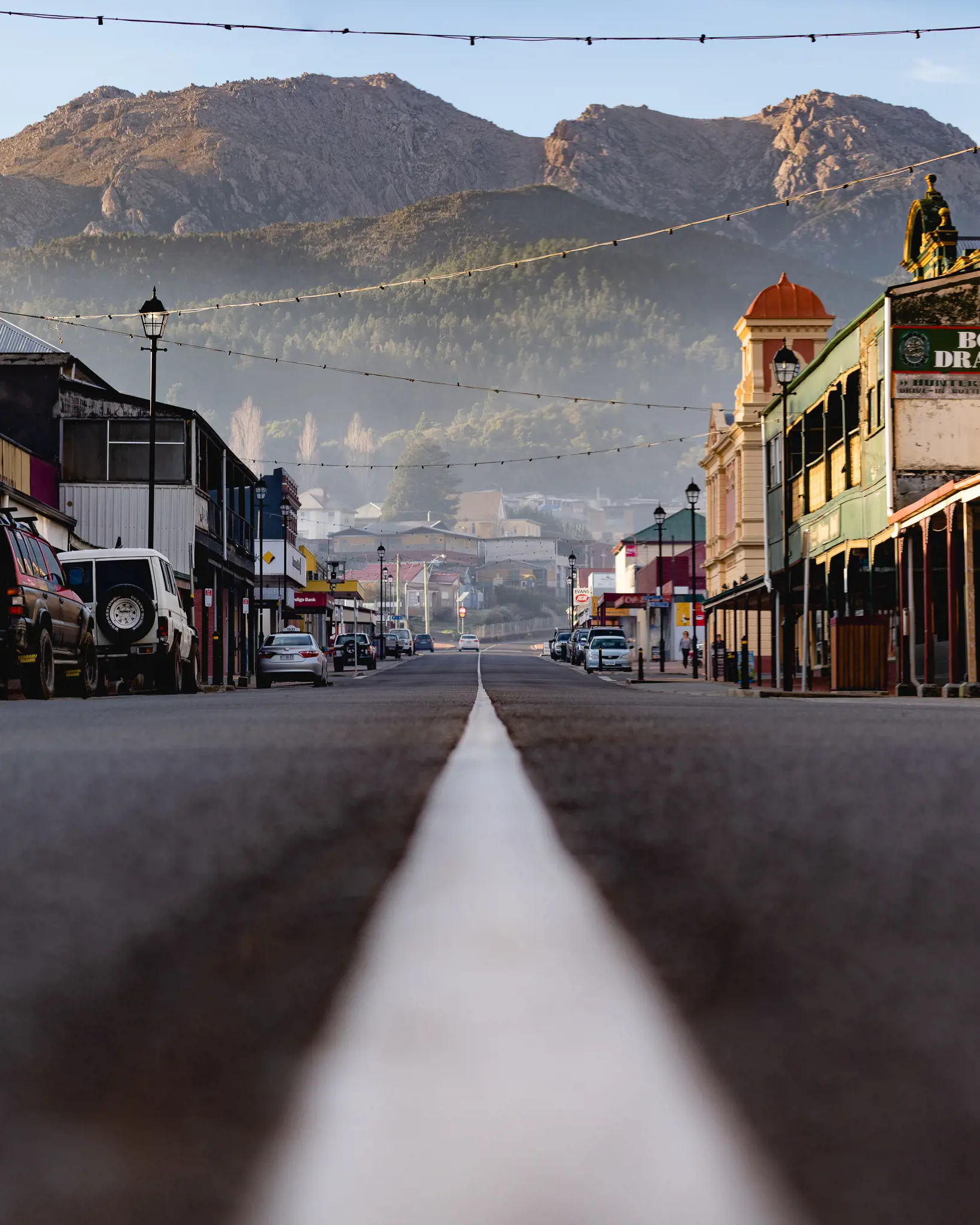 Streetscape of Queenstown, with dramatic hills and mountains in the backdrop.