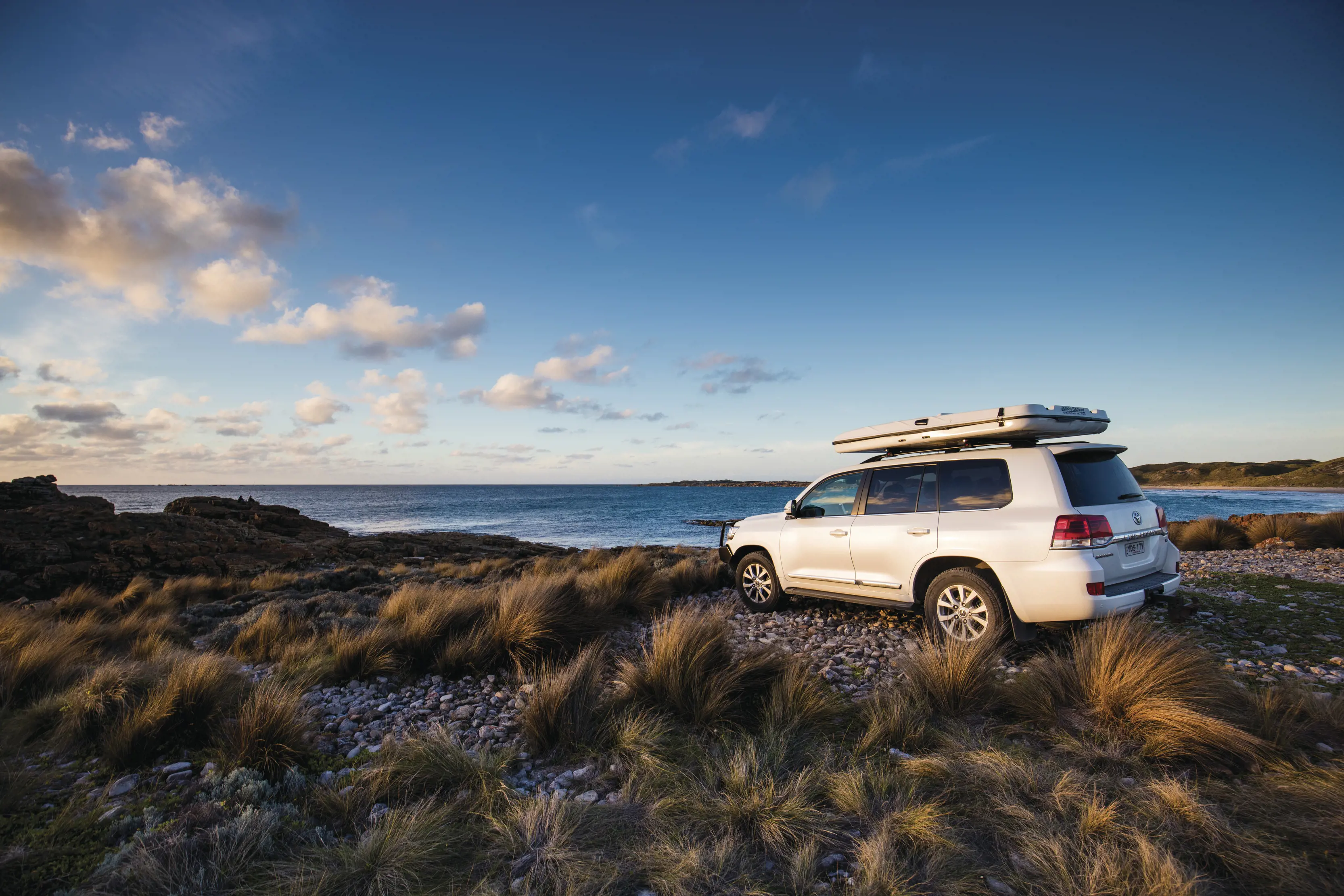 Four wheel drive parked at a beach in Marrawah, a small town in the north of the West Coast of Tasmania.